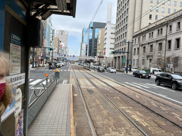 We were in the middle of a large street with cars going both ways on either side of the tram stop.