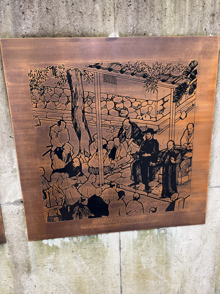 The bottom reads (Google Translate): "Saint Francis Xavier evangelizing around a well in Yamaguchi. Manufactured according to the etching technique, taking as a reference the painting found in the castle of Xavier in Spain."